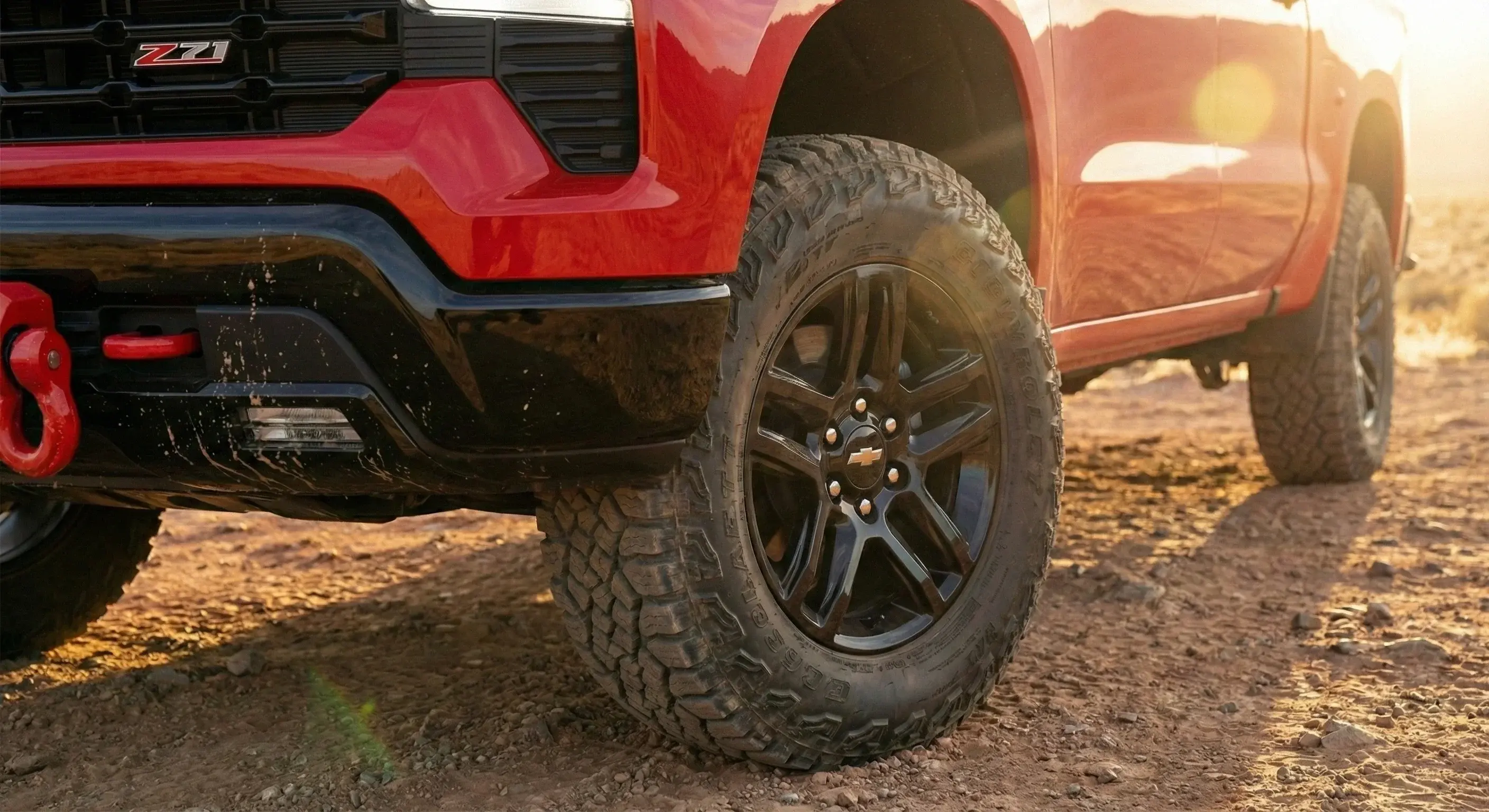 2026 Silverado Trail Boss 20-inch high gloss black wheels with Goodyear Wrangler Territory AT tires and red recovery hooks